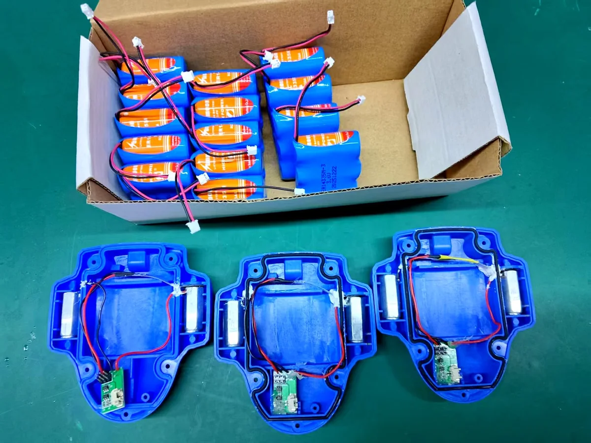 Lithium battery packs next to 4G-LS-809 housings being wired